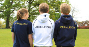 The backs of three Cranleigh School pupils wearing hoodies, 2015