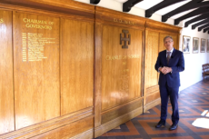 Cranleigh School Headmaster, Martin Reader, speakinf in front of honours boards